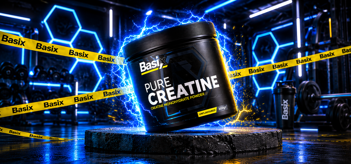 Basix Pure Creatine monohydrate powder tub on a podium in a gym